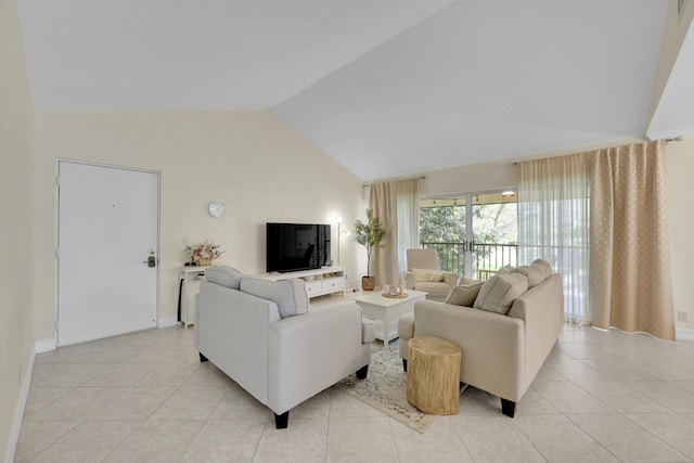 living room with light tile flooring and high vaulted ceiling