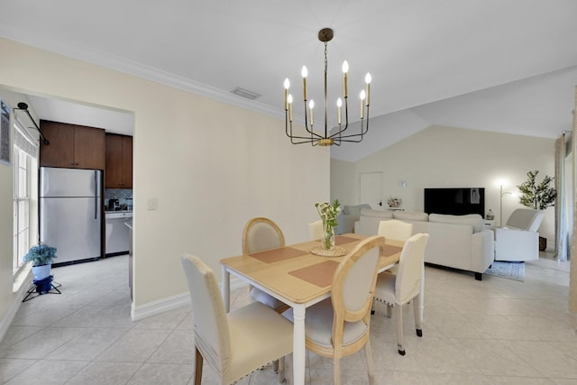 tiled dining space with crown molding, an inviting chandelier, and vaulted ceiling