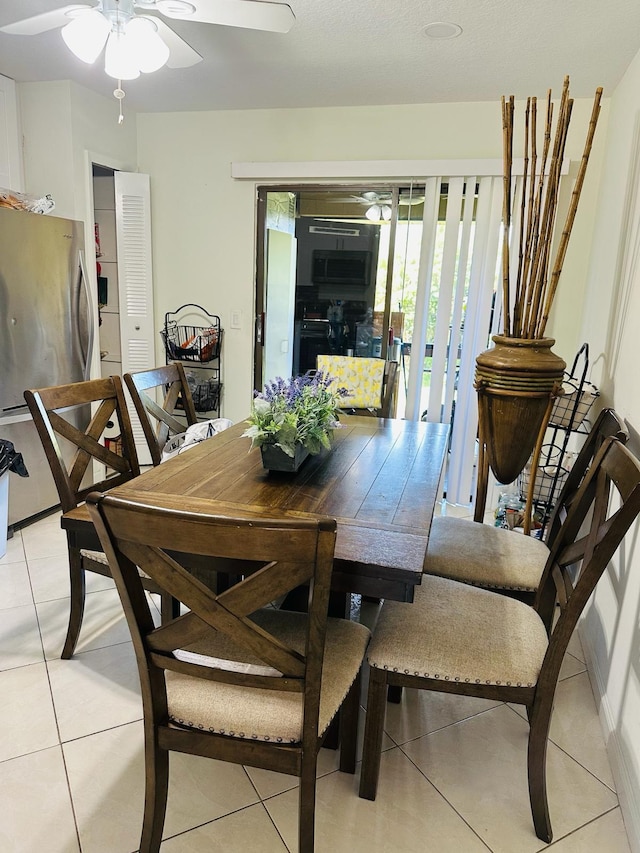 tiled dining area featuring ceiling fan