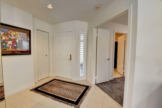 tiled entrance foyer with a textured ceiling