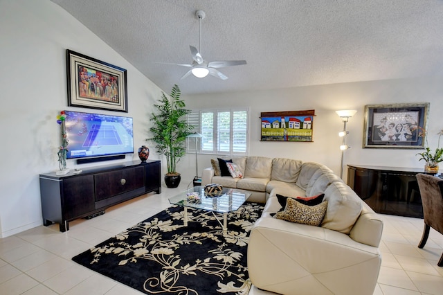 tiled living room featuring a textured ceiling, ceiling fan, and vaulted ceiling