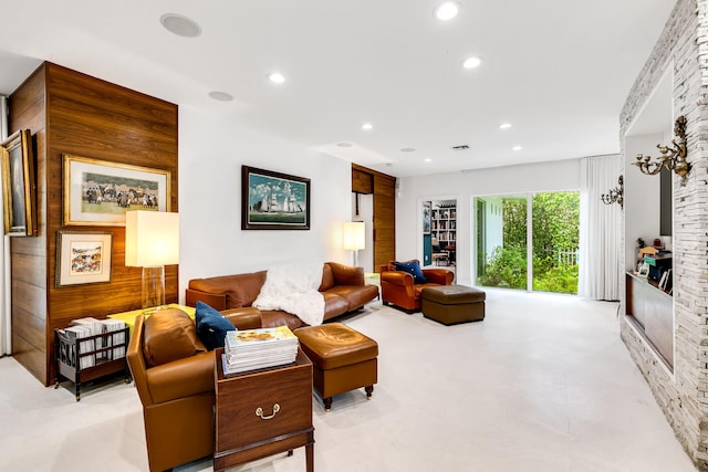 living room featuring wood walls and light tile floors