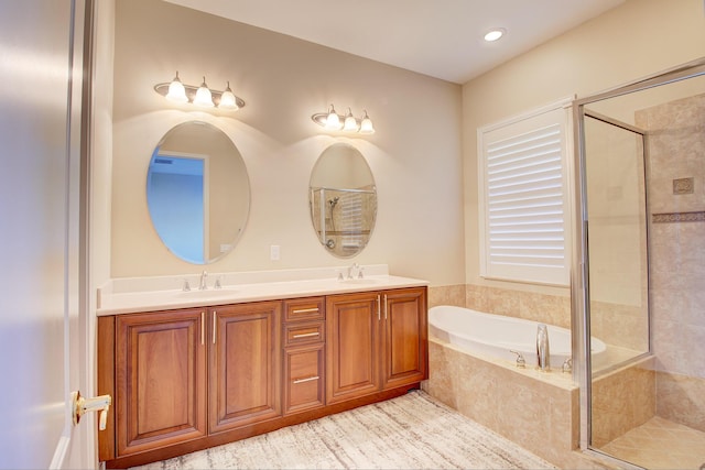 bathroom featuring vanity and shower with separate bathtub