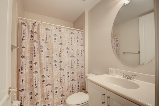 bathroom with a shower with shower curtain, vanity, and toilet