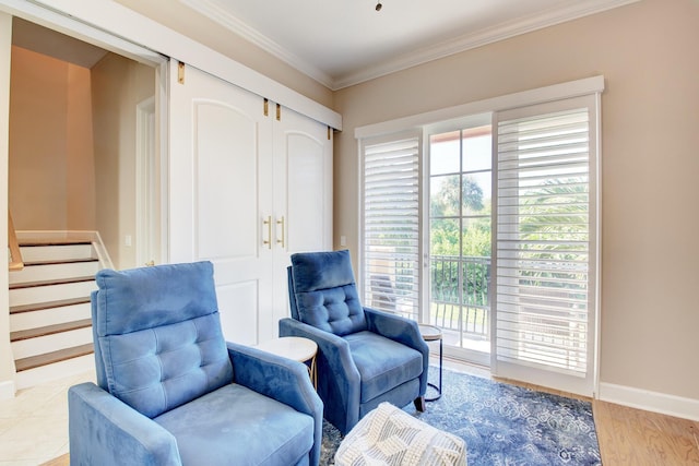 sitting room featuring light hardwood / wood-style floors and ornamental molding