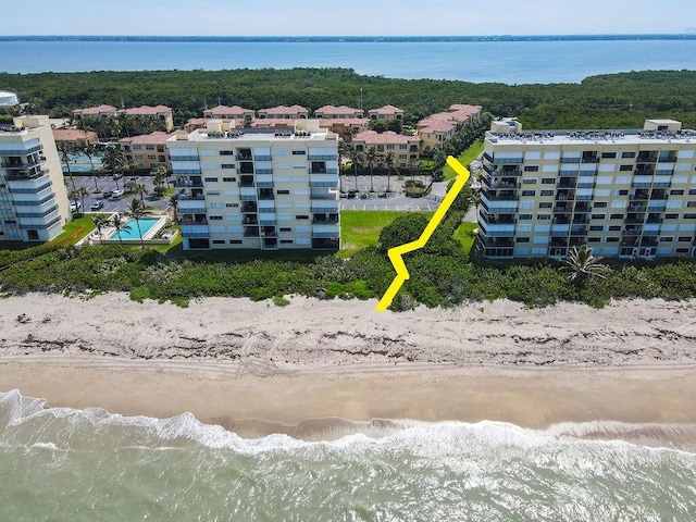 birds eye view of property featuring a water view and a view of the beach