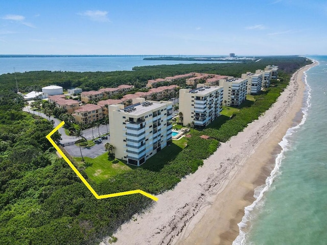 birds eye view of property featuring a view of the beach and a water view