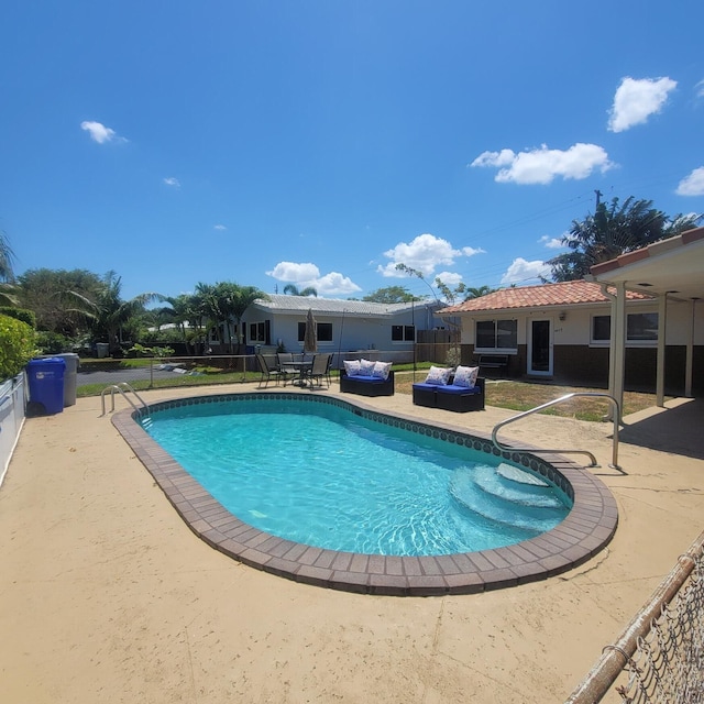 view of swimming pool featuring a patio area