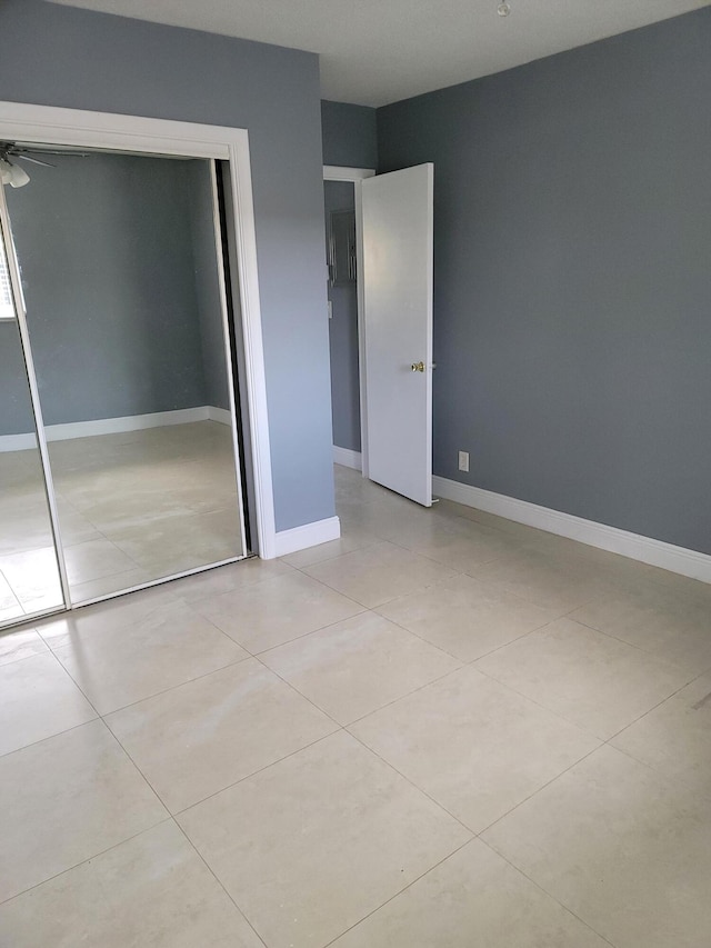 unfurnished bedroom featuring a closet and light tile flooring