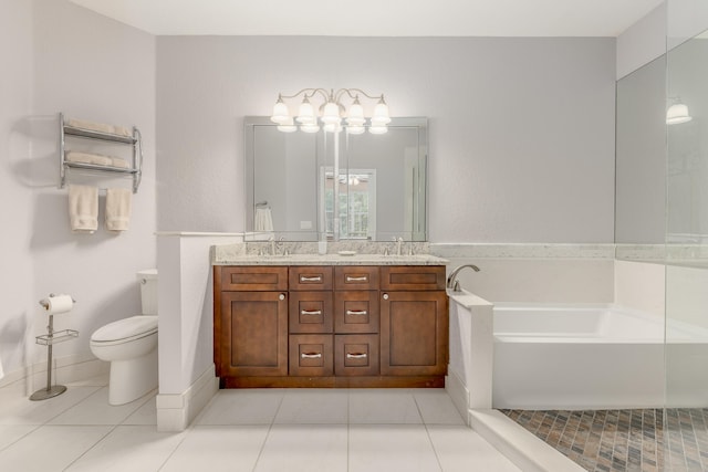 bathroom with dual vanity, tile floors, a bath to relax in, and toilet