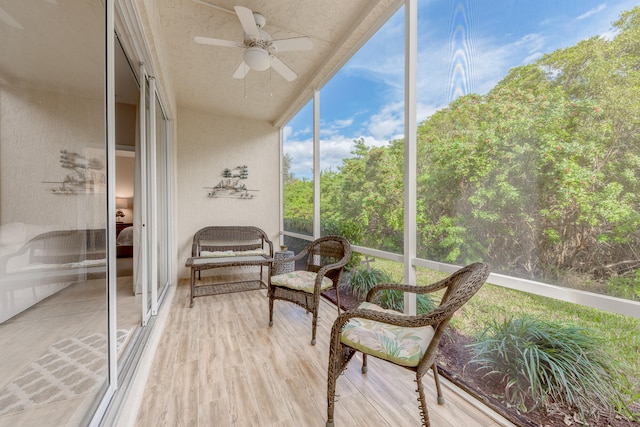 sunroom featuring ceiling fan