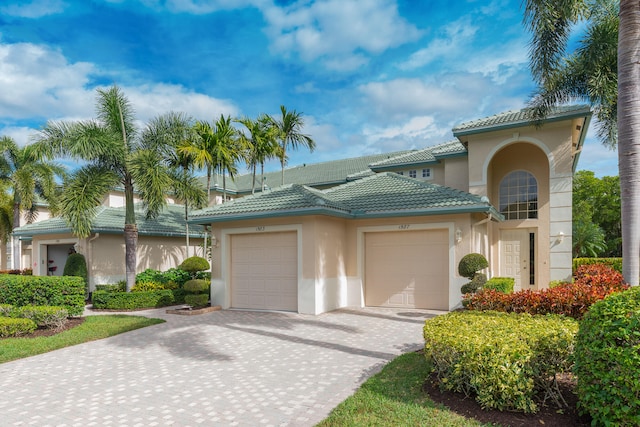 mediterranean / spanish-style house with a garage