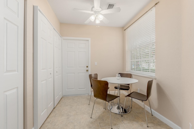 dining room with ceiling fan and light tile floors