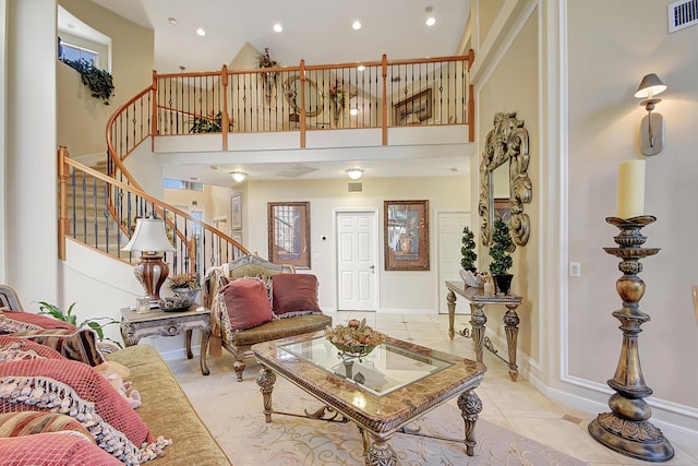 tiled living room featuring a high ceiling