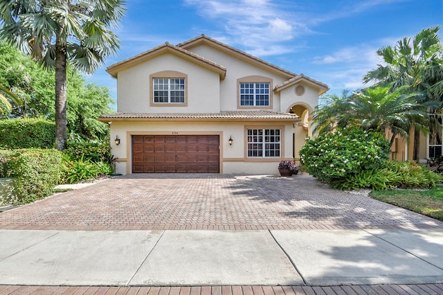 mediterranean / spanish-style home with a garage