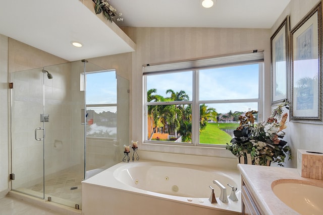 bathroom featuring vanity, a healthy amount of sunlight, and separate shower and tub