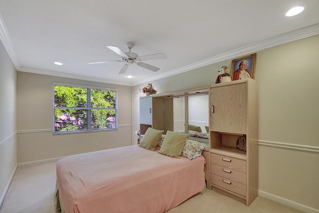 carpeted bedroom with ceiling fan and ornamental molding