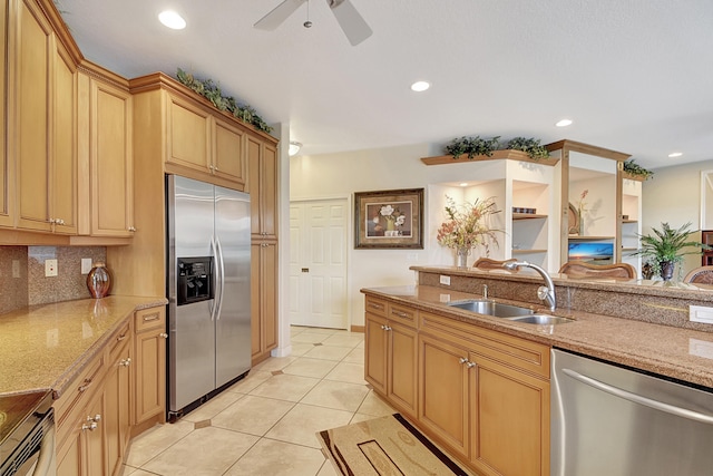 kitchen featuring ceiling fan, sink, decorative backsplash, light tile patterned flooring, and appliances with stainless steel finishes