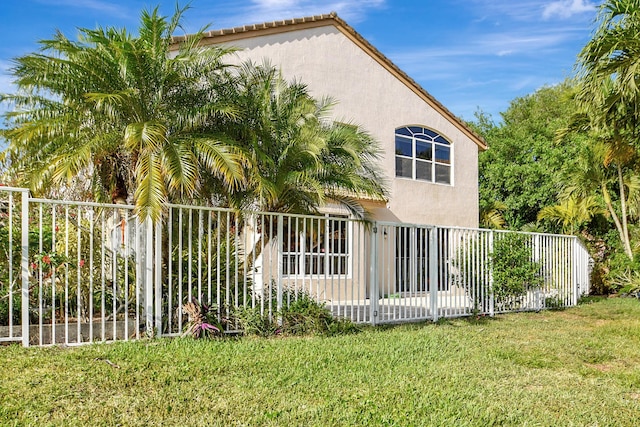 rear view of property with a lawn