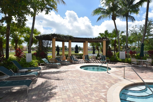 view of swimming pool featuring a pergola, a patio, and a hot tub