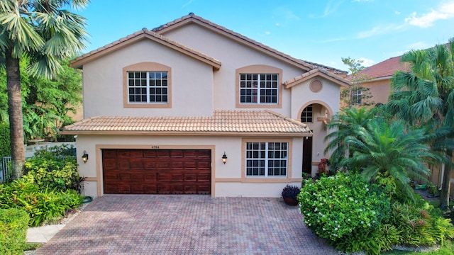 mediterranean / spanish-style house featuring a garage