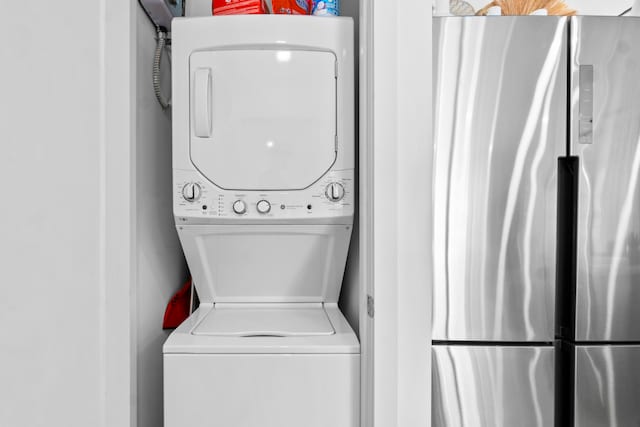 laundry room featuring stacked washer / drying machine