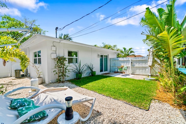 back of house with a patio area and central AC