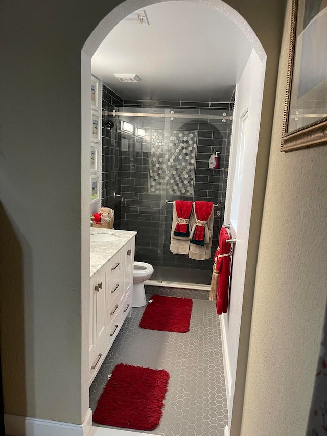 bathroom featuring walk in shower, toilet, tile floors, and vanity