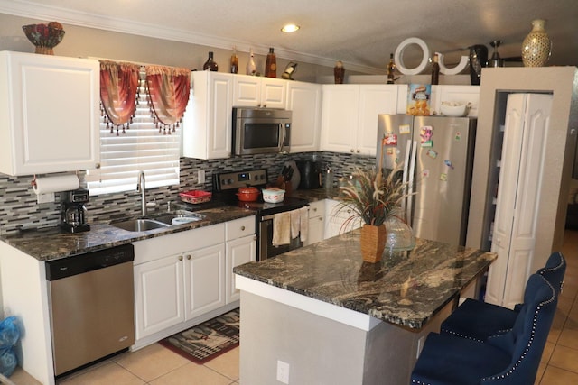 kitchen with ornamental molding, tasteful backsplash, stainless steel appliances, and light tile flooring