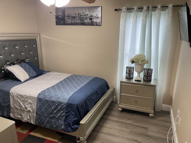 bedroom with dark hardwood / wood-style flooring