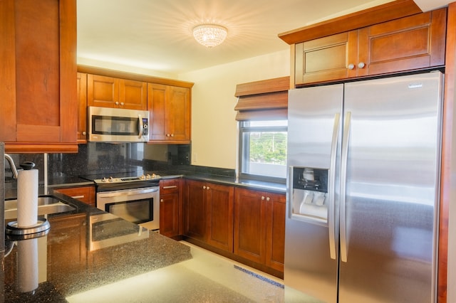 kitchen featuring appliances with stainless steel finishes, backsplash, and sink