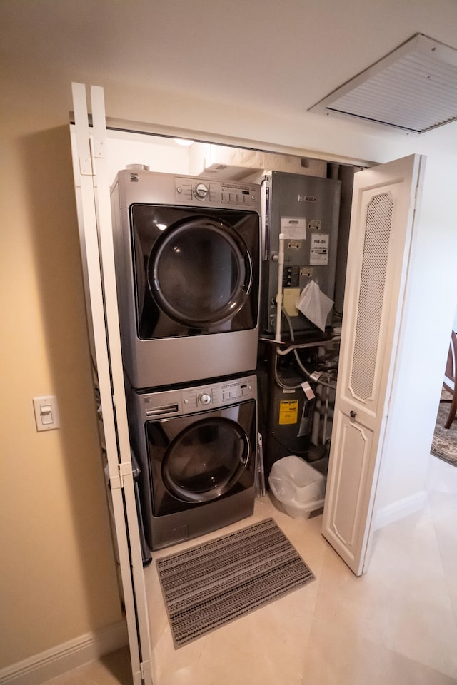 clothes washing area featuring stacked washer and dryer