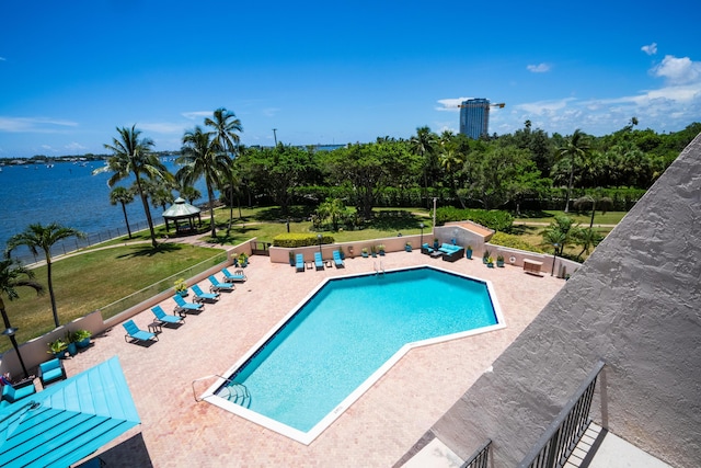 view of pool featuring a gazebo, a patio area, a water view, and a lawn