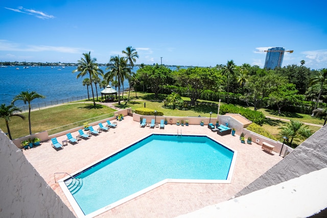 view of swimming pool featuring a gazebo, a patio area, a water view, and a lawn