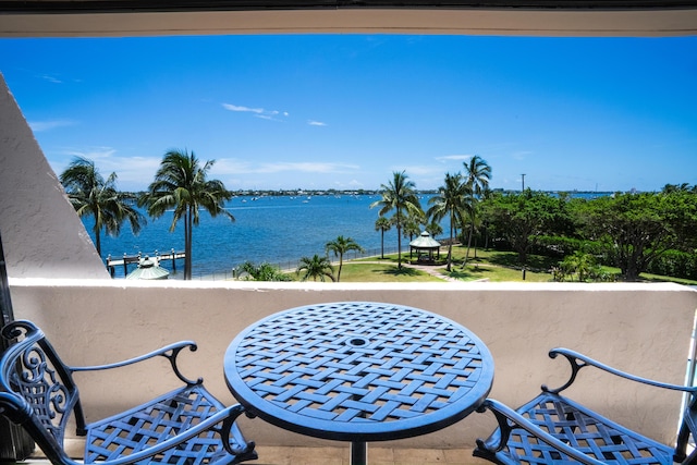 view of patio with a balcony and a water view