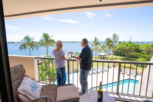 balcony featuring a water view