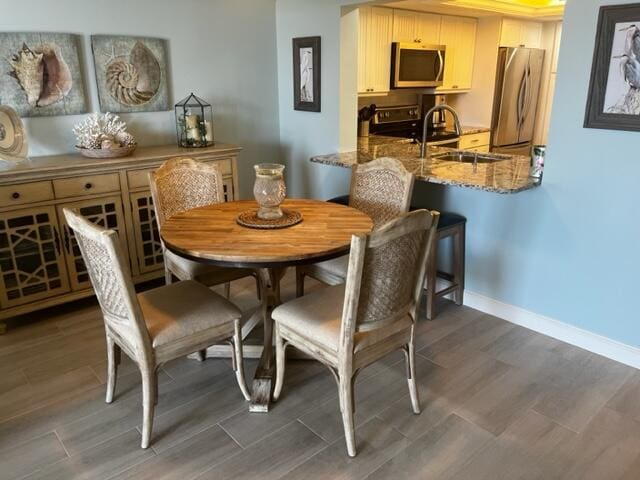 dining area featuring dark hardwood / wood-style floors and sink