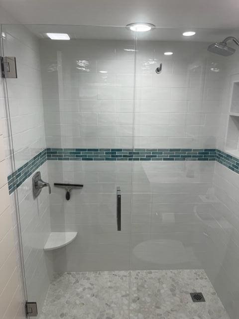 bathroom with a shower with door