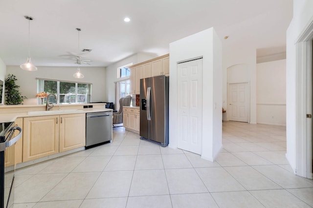 kitchen with ceiling fan, sink, stainless steel appliances, and light brown cabinetry