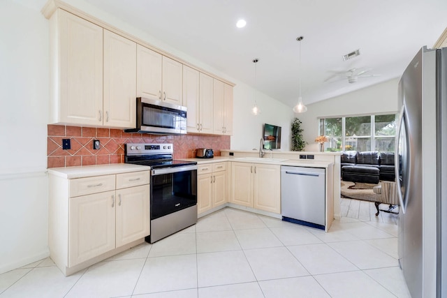 kitchen featuring kitchen peninsula, stainless steel appliances, ceiling fan, hanging light fixtures, and lofted ceiling