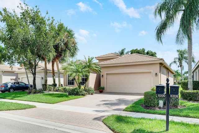 view of front of home with a front yard and a garage