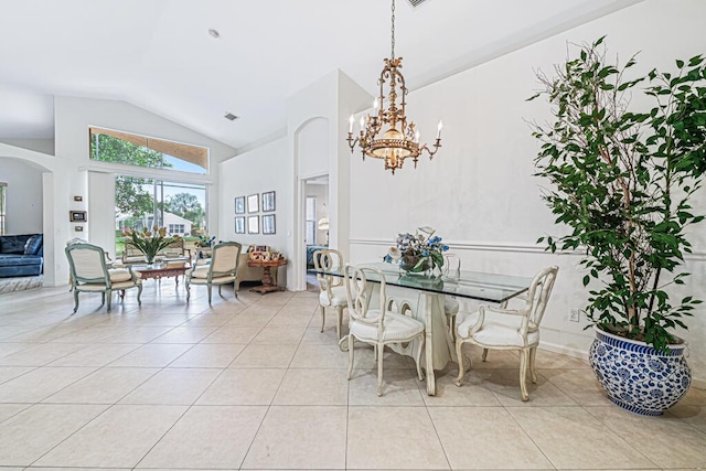 dining area featuring light tile patterned flooring, an inviting chandelier, and vaulted ceiling