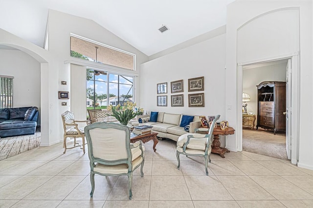 tiled living room with high vaulted ceiling