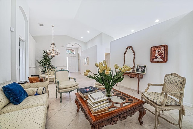 tiled living room with an inviting chandelier and vaulted ceiling