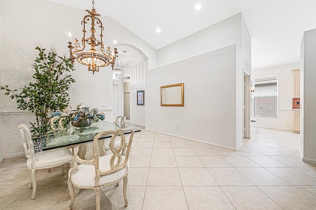 tiled dining room with a notable chandelier