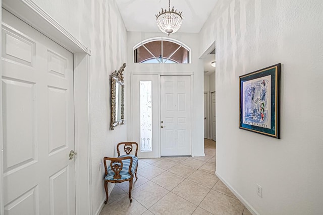 entrance foyer featuring light tile patterned flooring and an inviting chandelier