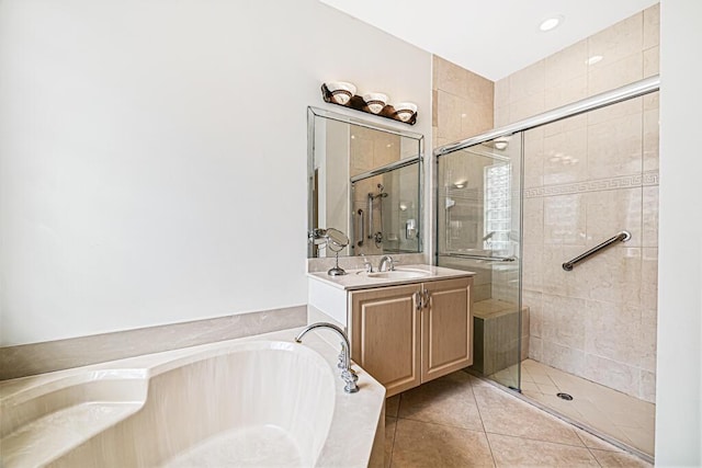 bathroom with tile patterned floors, vanity, and separate shower and tub