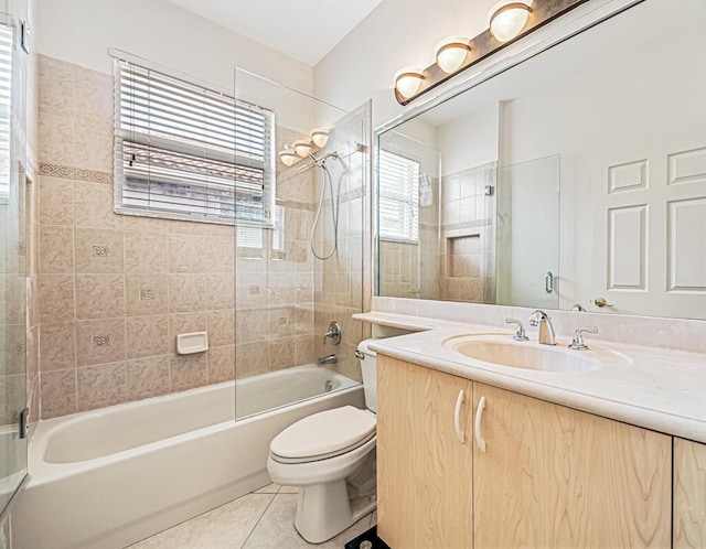 full bathroom featuring tile patterned flooring, vanity, toilet, and tiled shower / bath