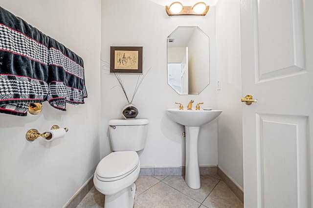 bathroom featuring tile patterned floors, toilet, and sink