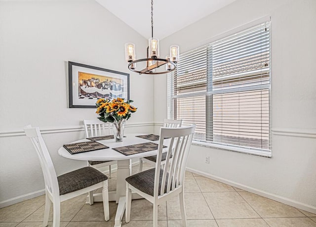 dining area featuring light tile patterned floors, an inviting chandelier, plenty of natural light, and lofted ceiling